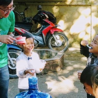 Children practise their teeth brushing technique with a student on the Projects Abroad Dentistry Internship in Vietnam. An intern gains dental work experience in Vietnam by teaching children how to brush their teeth during an outreach.